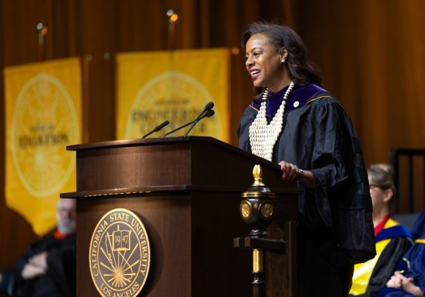Capri Maddox speaks from behind a podium.