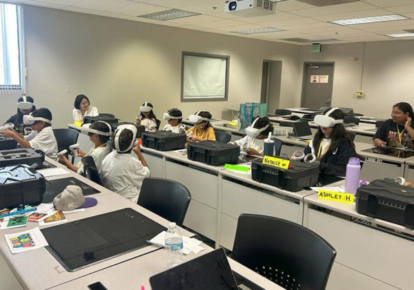 Students wearing VR headsets in a classroom.