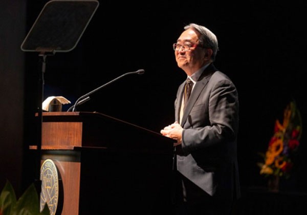 Cal State LA President, Leroy Morishita speaks from behind a podium.