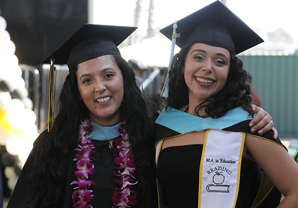 Two female graduates at commencement