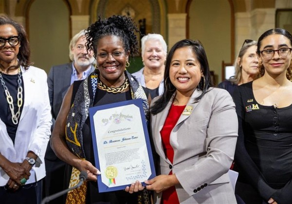 President of Cal State LA receives a proclamation certificate at Los Angeles City Hall, standing beside city officials and staff.