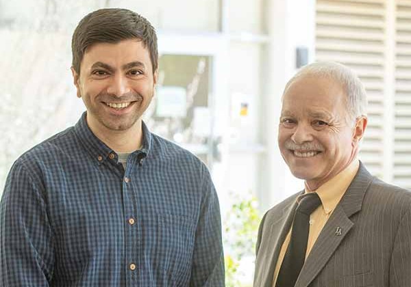 Lecturer Nidhin Patel (left) and Cal State LA President William Covino