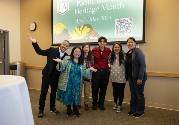 Cal State LA community members pose in front of a Pacific Islander Heritage Month presentation screen during an event in April 2024.