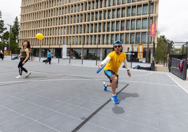 Cal State LA students play pickleball on an outdoor campus court near the Student Health Center.