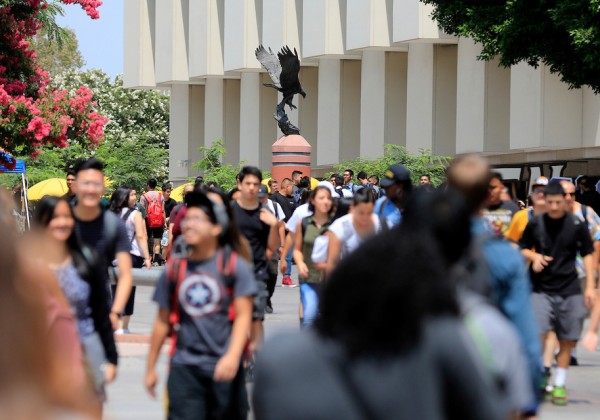 Students walk through the Cal State LA campus near the Golden Eagle statue.