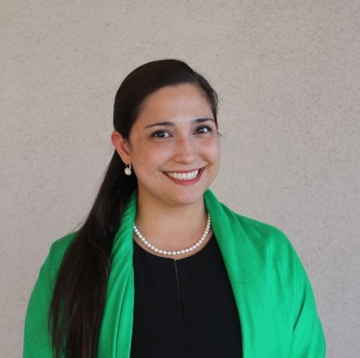 Headshot of Dr. Kristina Ruiz-Mesa in a black dress with a bright green shawl
