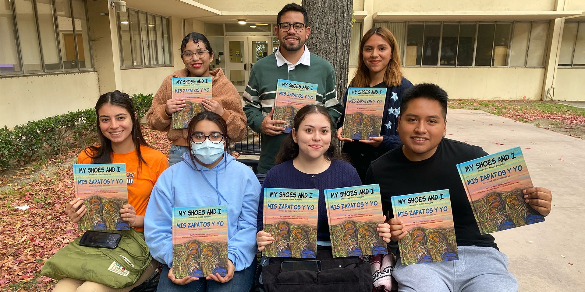 Students holding copy of book My Shoes and I