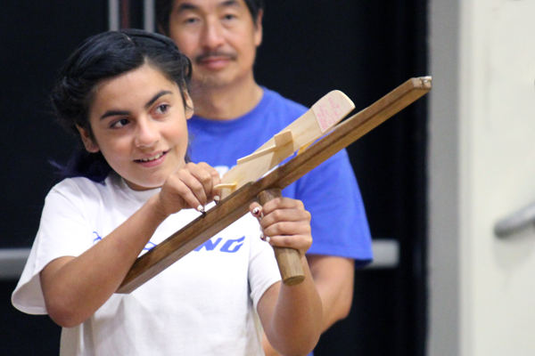 girl readies to launch plane