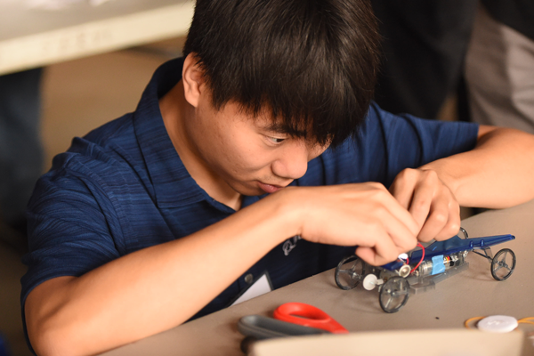 student building solar car