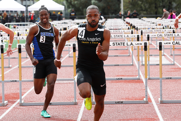 Image of a Cal State LA track star leading a hurdle race. 