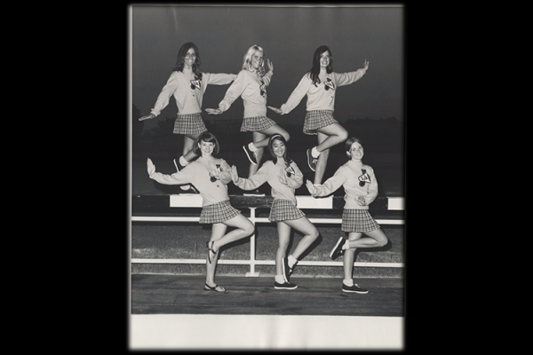 Six Cal State LA cheerleaders posing and smiling during the 1960s