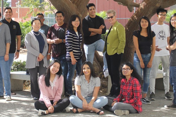 CAPS student cohort with faculty and staff by tree