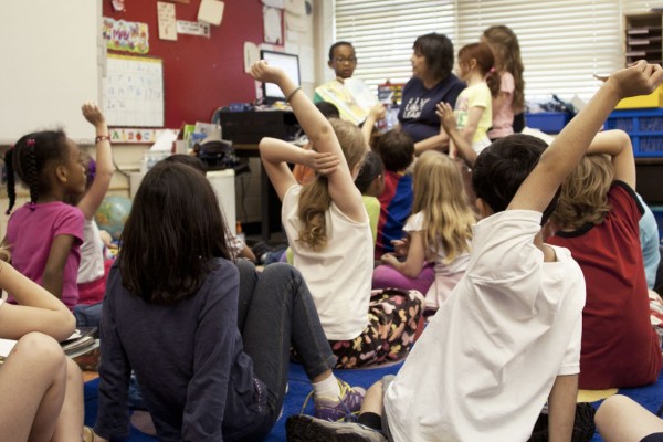 student raising hand in the classroom