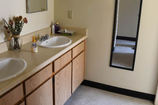 A bathroom with double sinks.