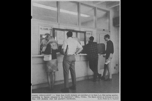 Four students standing at cashier window for spring enrollment