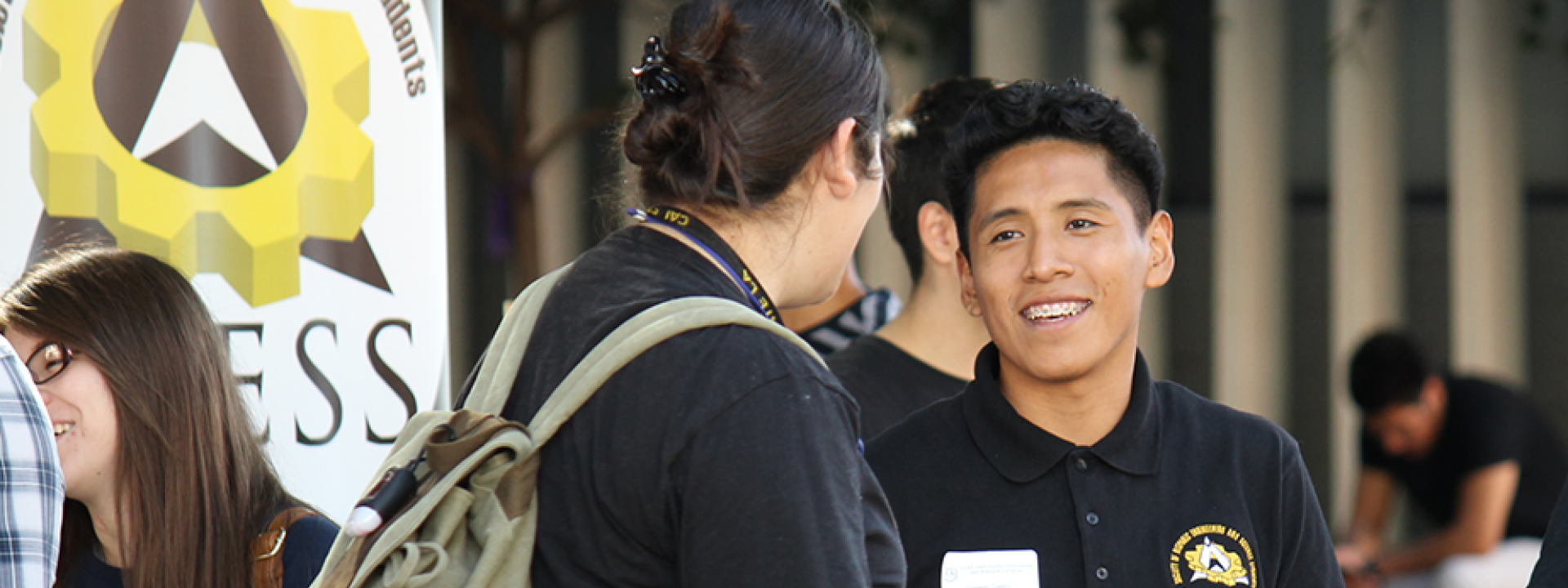 SHESS banner with male student speaking