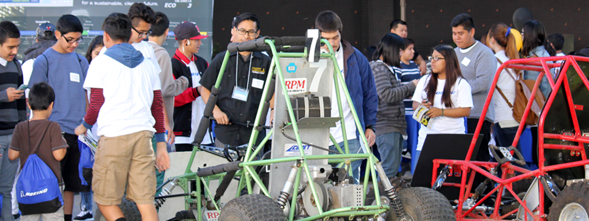 green and red baja cars in crowd