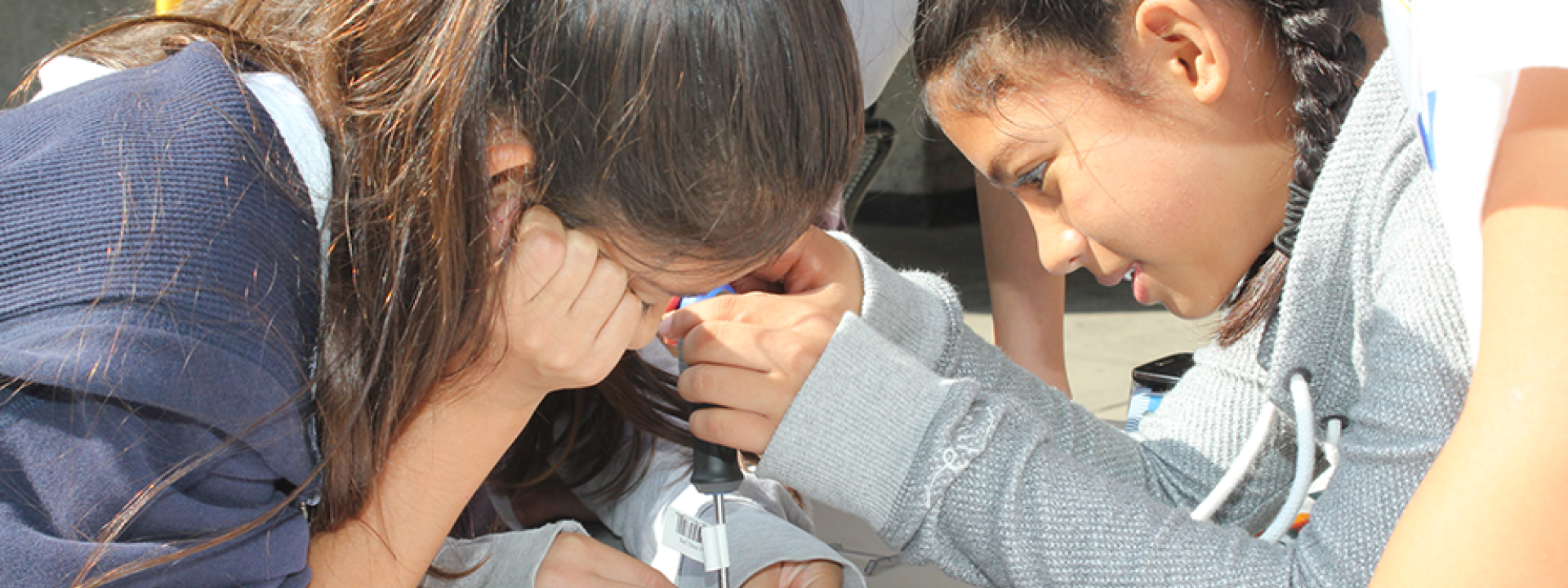 two young girls assembling