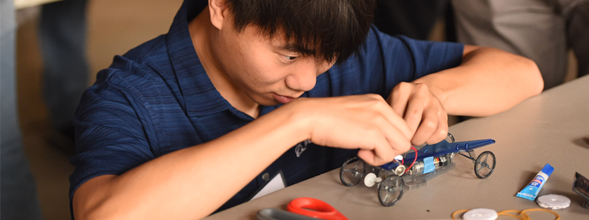 boy focuses on building a car kit