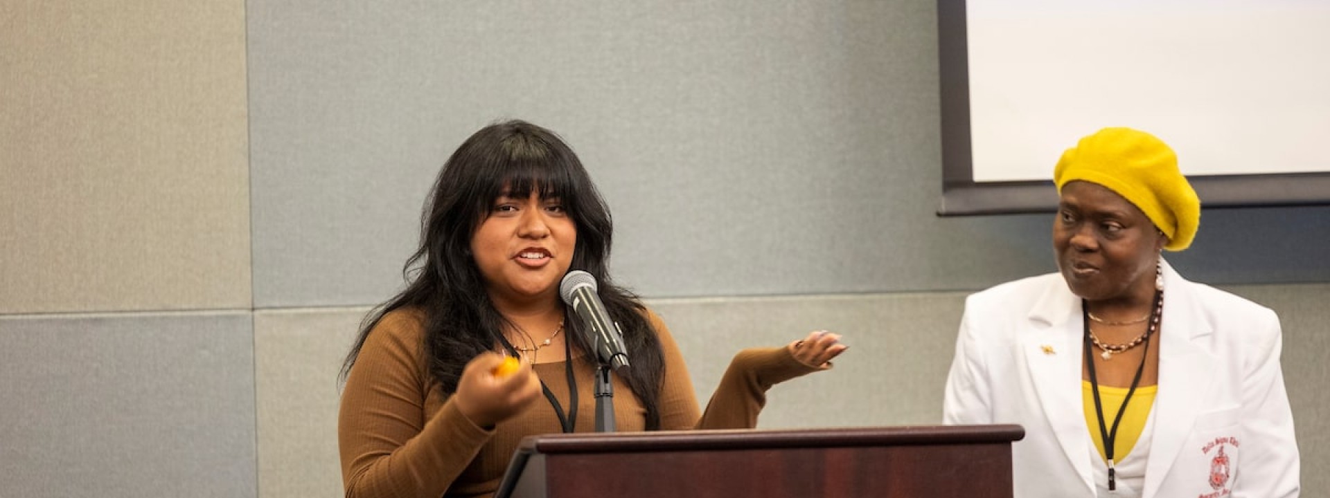 Female student at podium on stage