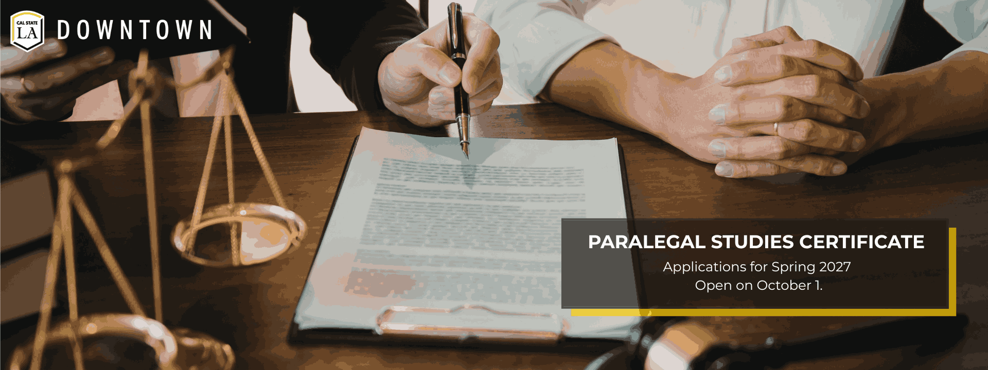 Paralegal and attorney working together at desk.