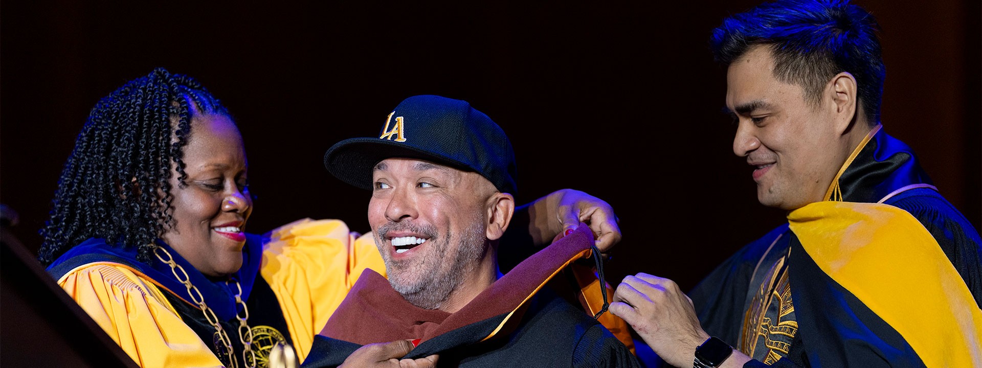 Jo Koy being hooded by President Eanes and Trustee Vargas