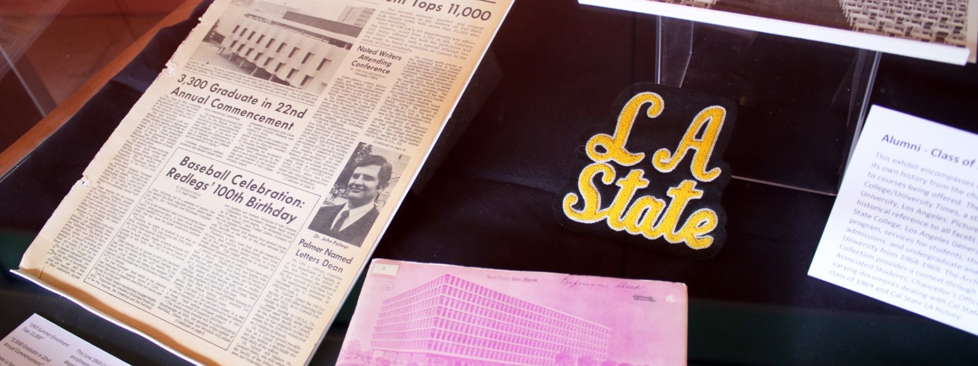 Alumni reunion memorabilia including a College Times issue from 1969 and LA State patch