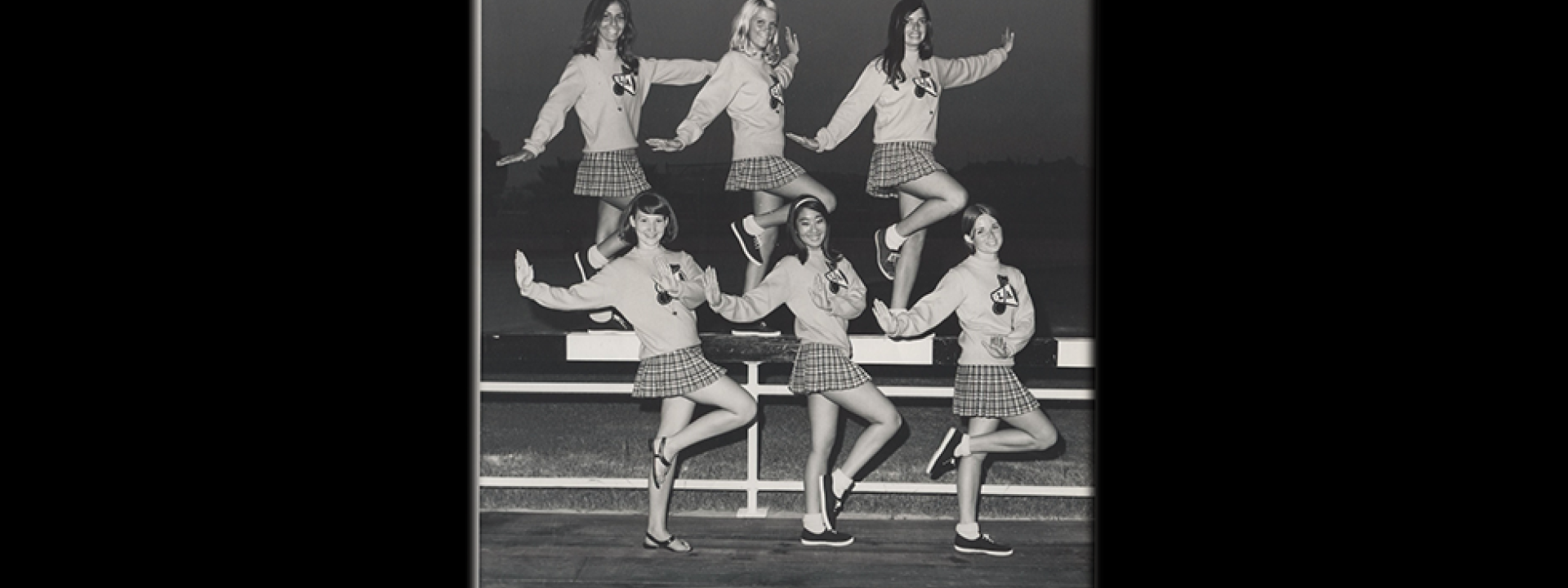 Six Cal State LA cheerleaders posing and smiling during the 1960s