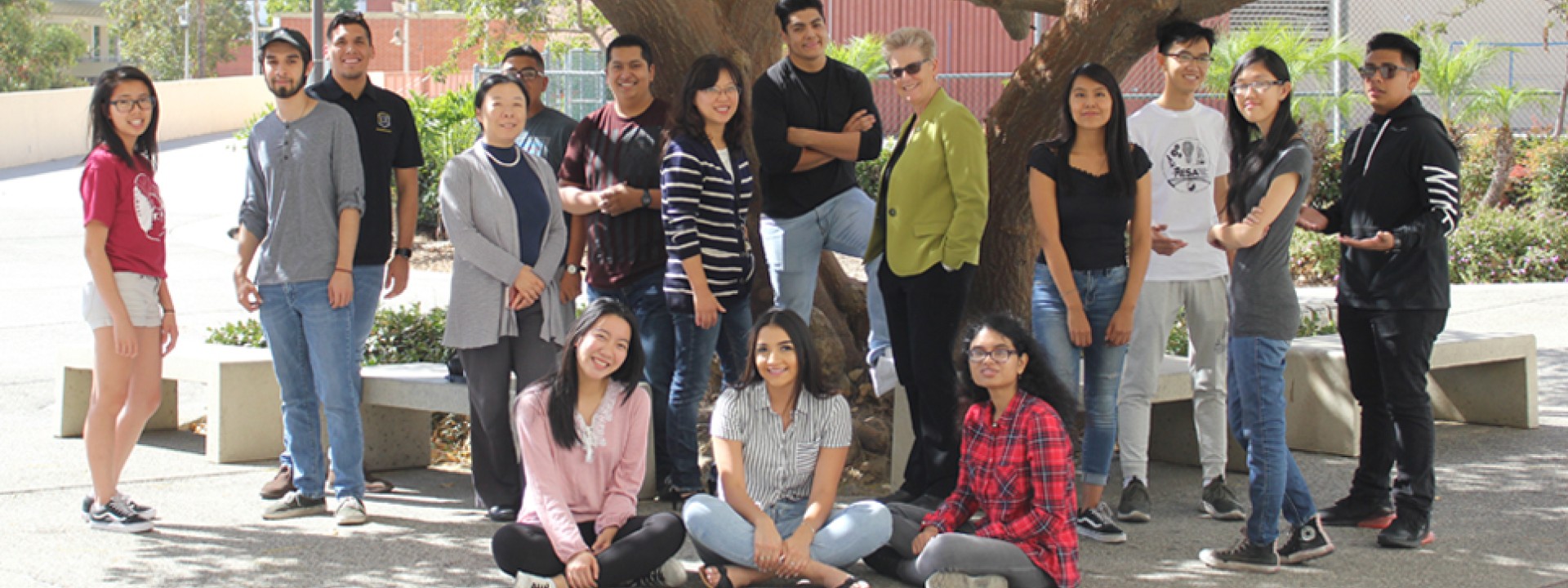 CAPS student cohort with faculty and staff by tree