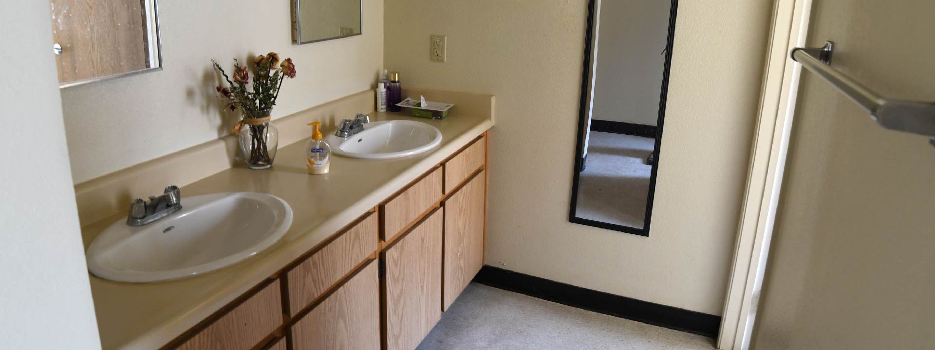A bathroom with double sinks.