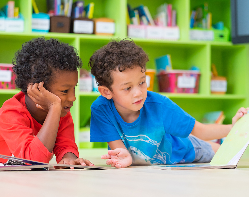 two children reading a book