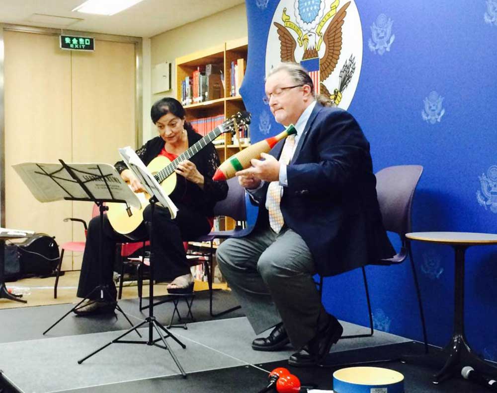 Professor John Kennedy playing instrument with another person