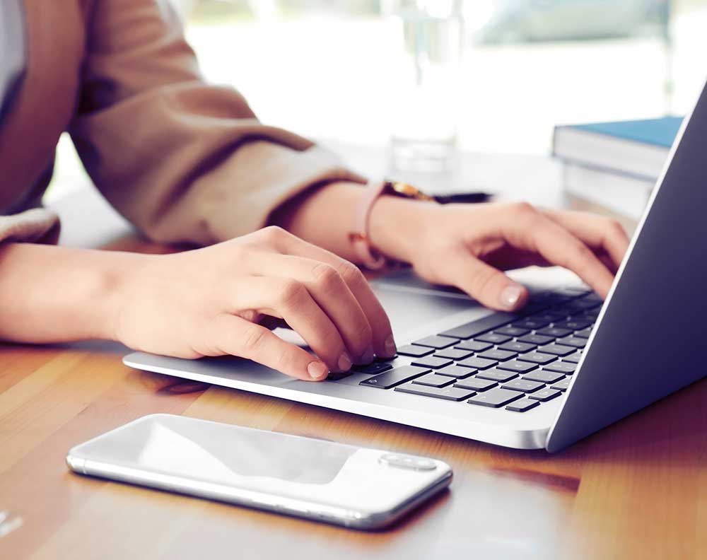 woman typing into a laptop