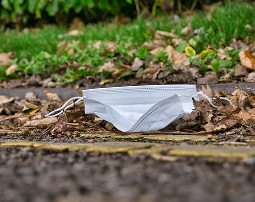 Disposable mask on street in urban setting