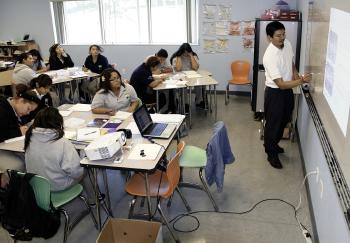 A teacher educating students in an urban school.