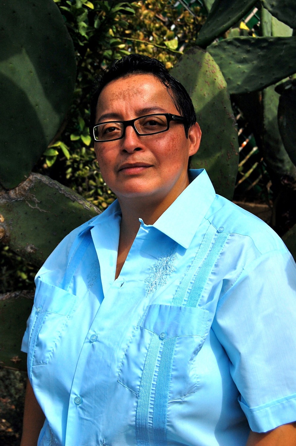 Portrait of Reyes in front of foliage