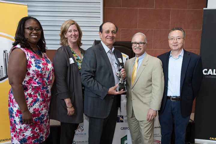 biotech leader, willie zuniga, poses for a group photo
