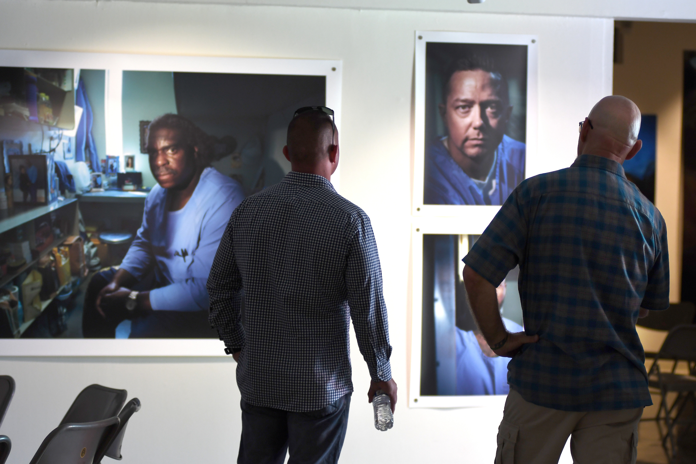 Two guests look at artwork on the walls